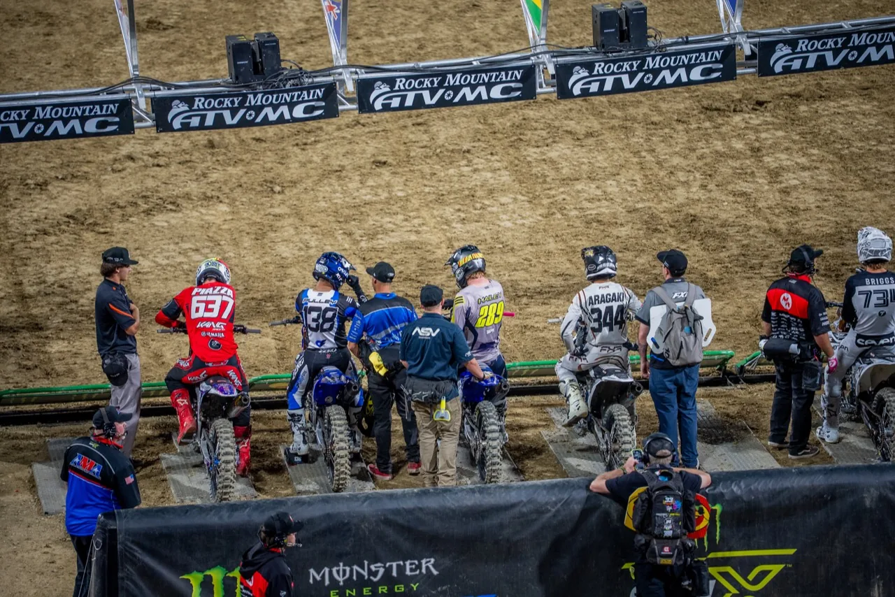 Professional Supercross athletes lined up at the starting gate